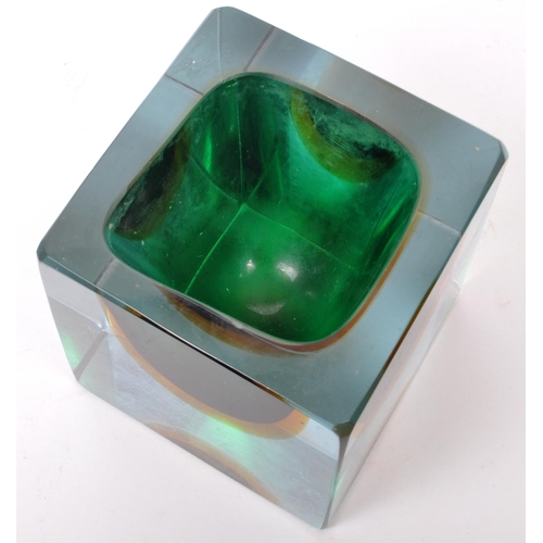 90 - A vintage mid 20th century studio art glass vase. The vase of cube form, with green and yellow colou... 