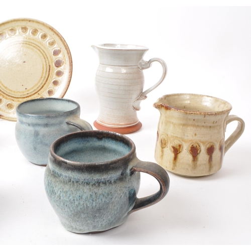 91 - A collection of nine 20th-century studio pottery pieces and stoneware, including ceramic blue glazed... 