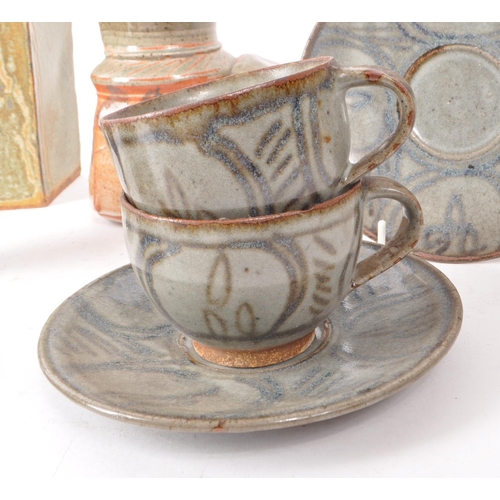 93 - A collection of contemporary studio pottery stoneware pieces, comprising of four cups, four saucers,... 