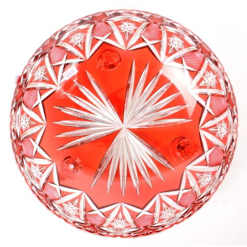 95 - A vintage mid 20th century cranberry cut glass centerpiece dish. The dish raised on scrolled feet, f... 