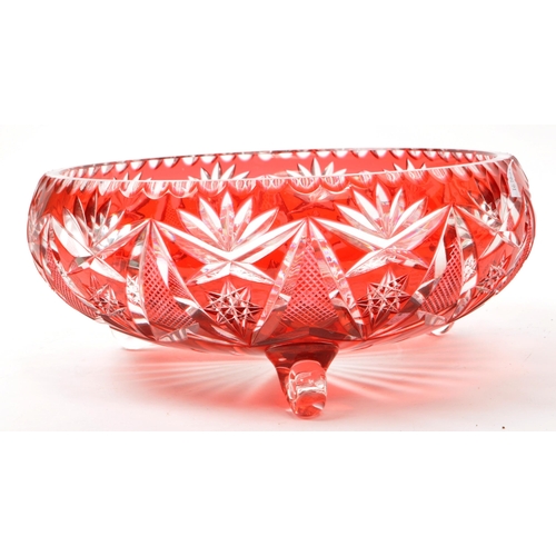 95 - A vintage mid 20th century cranberry cut glass centerpiece dish. The dish raised on scrolled feet, f... 