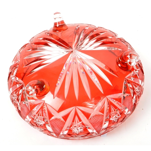 95 - A vintage mid 20th century cranberry cut glass centerpiece dish. The dish raised on scrolled feet, f... 