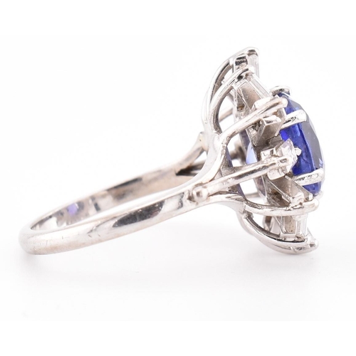 1 - An 18ct white gold tanzanite and diamond cluster ring. The 18ct white gold ring set with a central c... 