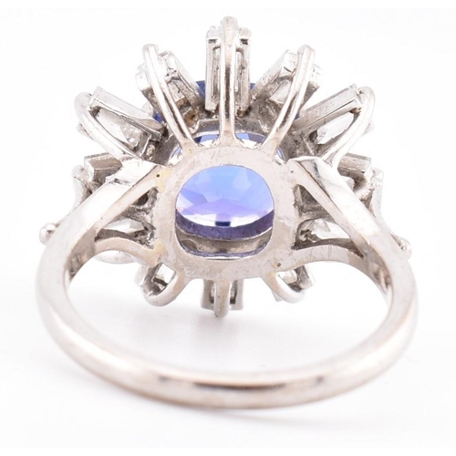 1 - An 18ct white gold tanzanite and diamond cluster ring. The 18ct white gold ring set with a central c... 