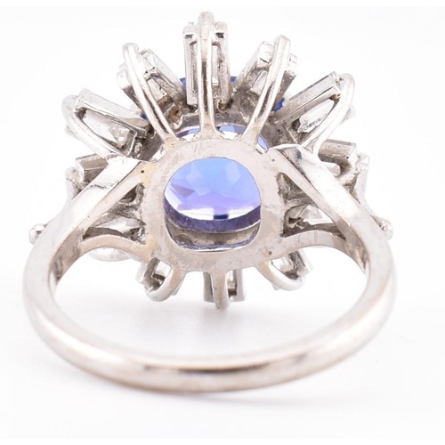 1 - An 18ct white gold tanzanite and diamond cluster ring. The 18ct white gold ring set with a central c... 