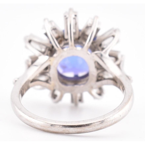 1 - An 18ct white gold tanzanite and diamond cluster ring. The 18ct white gold ring set with a central c... 