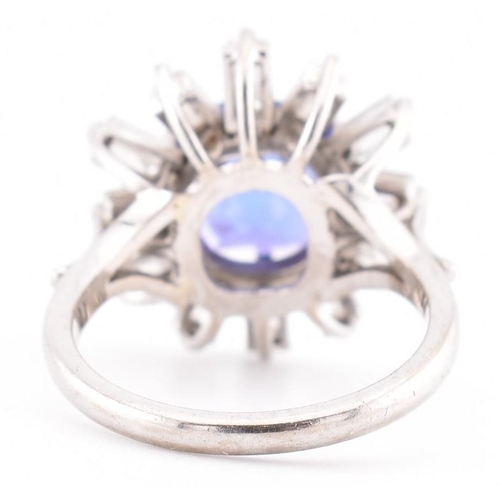 1 - An 18ct white gold tanzanite and diamond cluster ring. The 18ct white gold ring set with a central c... 