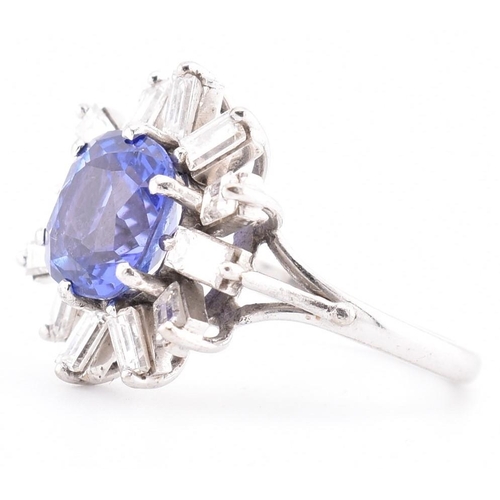 1 - An 18ct white gold tanzanite and diamond cluster ring. The 18ct white gold ring set with a central c... 