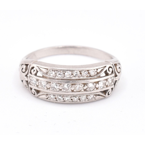 100 - A 1920S platinum and diamond ring. The ring set with three rows of single cut diamonds with pierced ... 