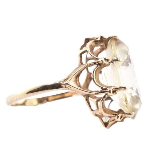 101 - A hallmarked 9ct gold and citrine cocktail ring. The 9ct yellow gold ring having a single oval cut c... 