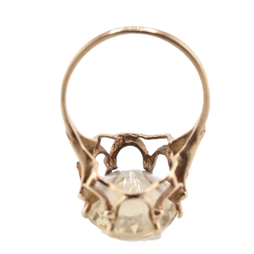 101 - A hallmarked 9ct gold and citrine cocktail ring. The 9ct yellow gold ring having a single oval cut c... 