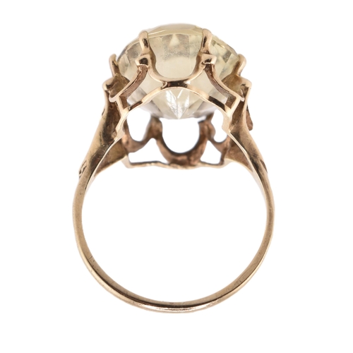 101 - A hallmarked 9ct gold and citrine cocktail ring. The 9ct yellow gold ring having a single oval cut c... 