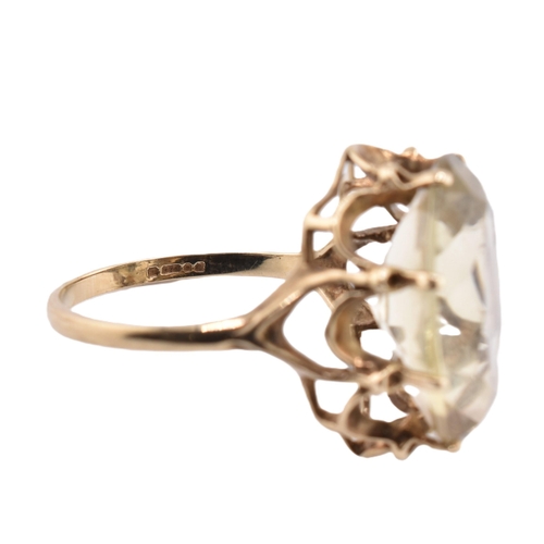 101 - A hallmarked 9ct gold and citrine cocktail ring. The 9ct yellow gold ring having a single oval cut c... 