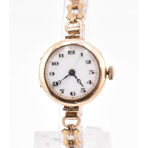 106 - A hallmarked 9ct gold wristwatch with a rolled gold bracelet strap. The hallmarked 9ct yellow gold w... 