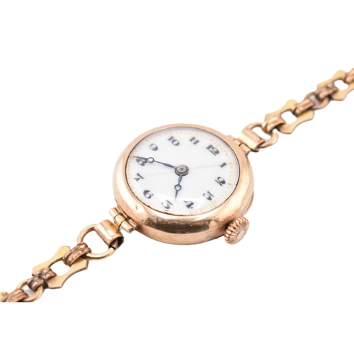 106 - A hallmarked 9ct gold wristwatch with a rolled gold bracelet strap. The hallmarked 9ct yellow gold w... 