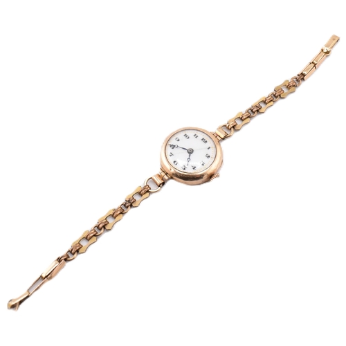 106 - A hallmarked 9ct gold wristwatch with a rolled gold bracelet strap. The hallmarked 9ct yellow gold w... 