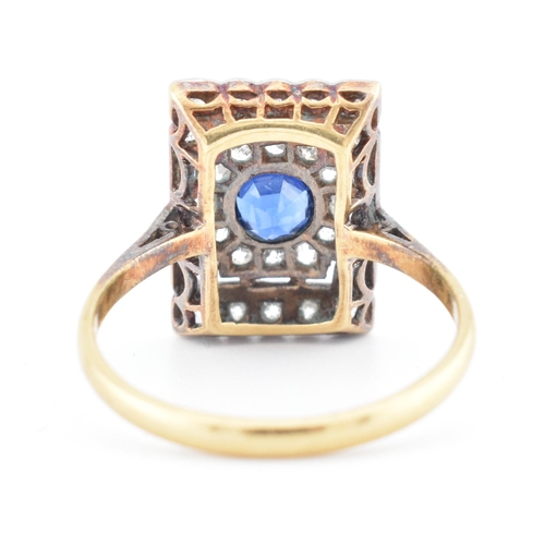 107 - An Art Deco sapphire and diamond panel ring. The ring is set with a central round cut sapphire, fram... 