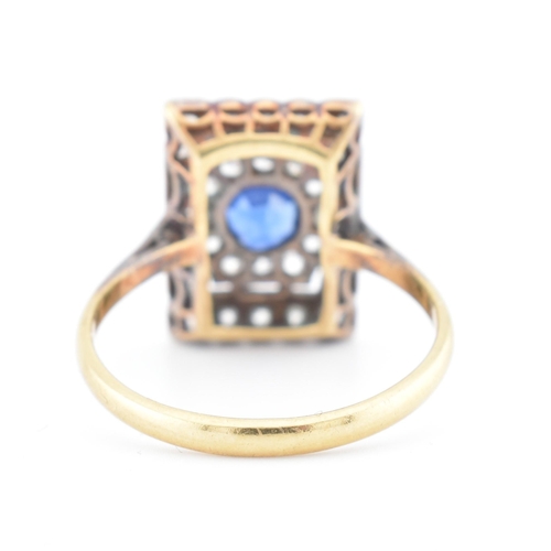 107 - An Art Deco sapphire and diamond panel ring. The ring is set with a central round cut sapphire, fram... 