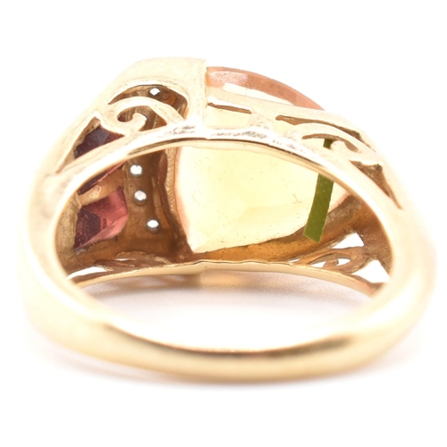 108 - A hallmarked 9ct gold citrine, garnet and diamond cocktail ring. The 9ct yellow gold ring set with a... 