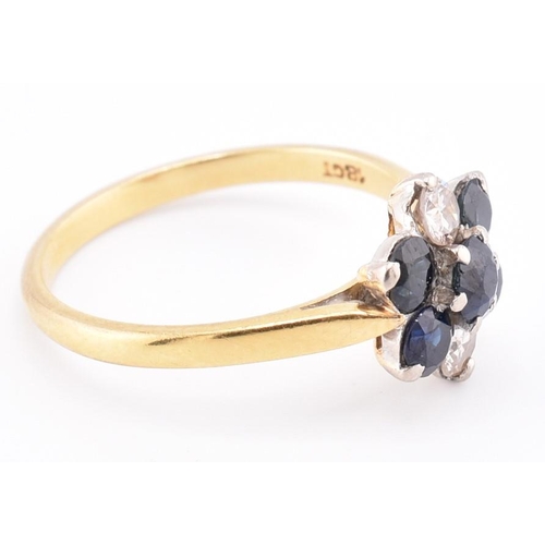 114 - An 18ct gold sapphire and diamond cluster ring. The 18ct yellow gold ring having a flower-shaped hea... 