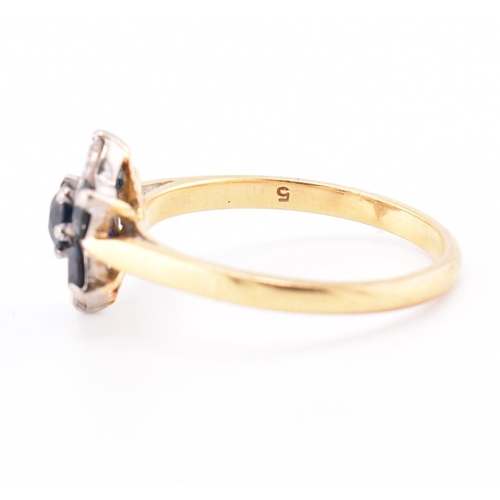 114 - An 18ct gold sapphire and diamond cluster ring. The 18ct yellow gold ring having a flower-shaped hea... 