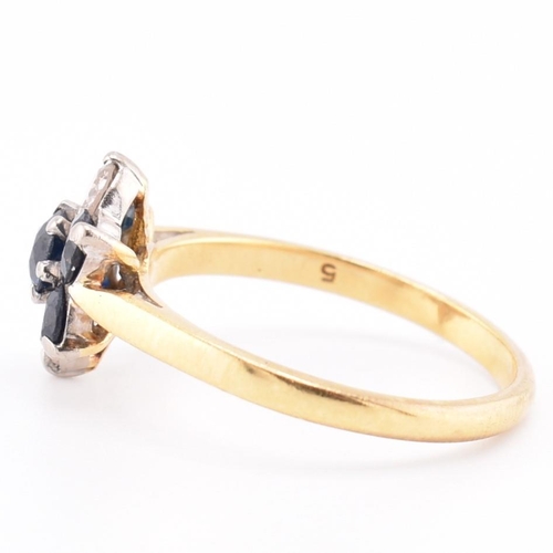 114 - An 18ct gold sapphire and diamond cluster ring. The 18ct yellow gold ring having a flower-shaped hea... 