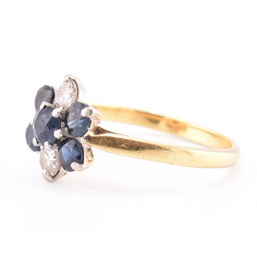 114 - An 18ct gold sapphire and diamond cluster ring. The 18ct yellow gold ring having a flower-shaped hea... 