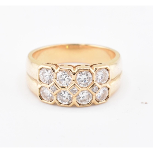 120 - An 18ct gold and diamond cluster ring. The 18ct yellow gold ring set with two rows of round brillian... 