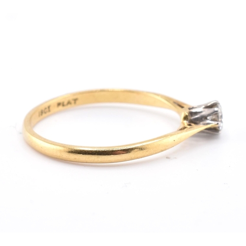 124 - An 18ct gold, platinum and diamond solitaire ring. The 18ct yellow gold ring set with a single eight... 