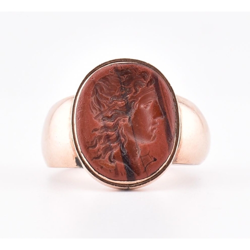 126 - A 19th century gold intaglio seal ring. The rose gold ring having an oval lava intaglio depicting th... 