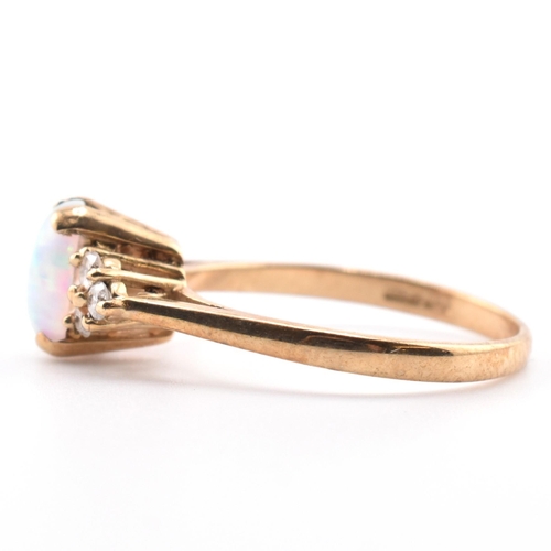 128 - A hallmarked 9ct gold synthetic opal and diamond ring. The 9ct yellow gold ring set with an oval syn... 