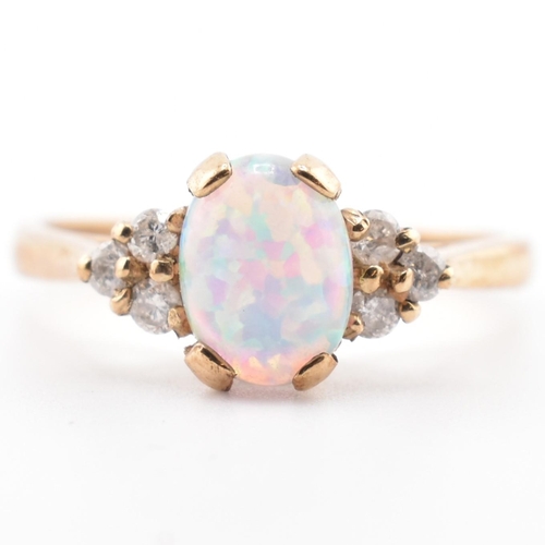 128 - A hallmarked 9ct gold synthetic opal and diamond ring. The 9ct yellow gold ring set with an oval syn... 