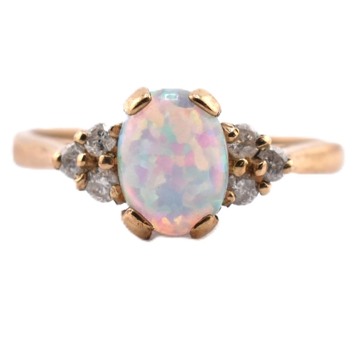 128 - A hallmarked 9ct gold synthetic opal and diamond ring. The 9ct yellow gold ring set with an oval syn... 