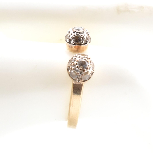 133 - A hallmarked 9ct gold and CZ ball torque ring. The 9ct yellow gold torque ring having two ball finia... 