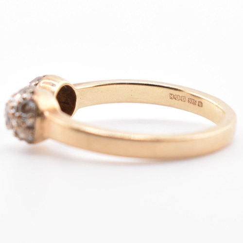 133 - A hallmarked 9ct gold and CZ ball torque ring. The 9ct yellow gold torque ring having two ball finia... 