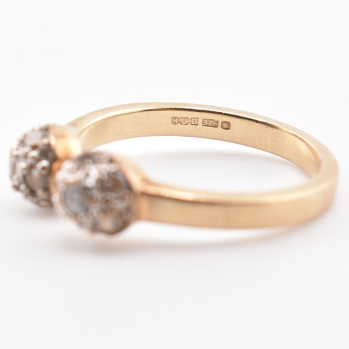 133 - A hallmarked 9ct gold and CZ ball torque ring. The 9ct yellow gold torque ring having two ball finia... 