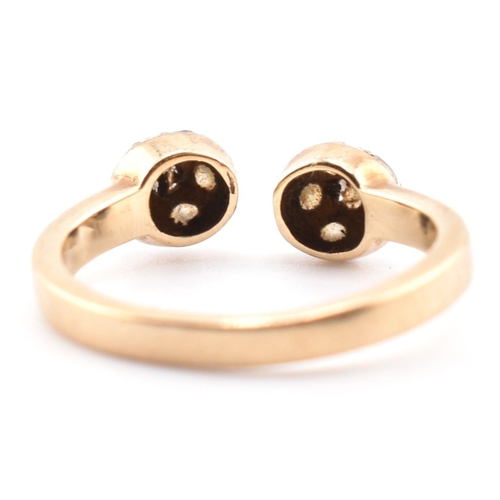 133 - A hallmarked 9ct gold and CZ ball torque ring. The 9ct yellow gold torque ring having two ball finia... 