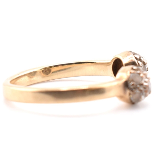 133 - A hallmarked 9ct gold and CZ ball torque ring. The 9ct yellow gold torque ring having two ball finia... 