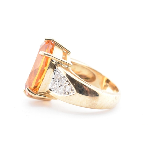 135 - A hallmarked 9ct gold, citrine and diamond ring. The 9ct yellow gold ring set with a central six cla... 