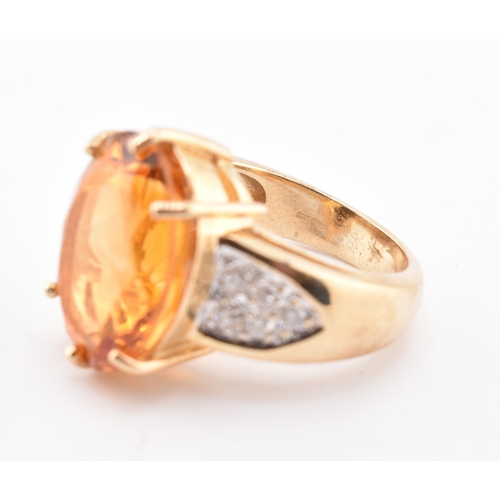 135 - A hallmarked 9ct gold, citrine and diamond ring. The 9ct yellow gold ring set with a central six cla... 