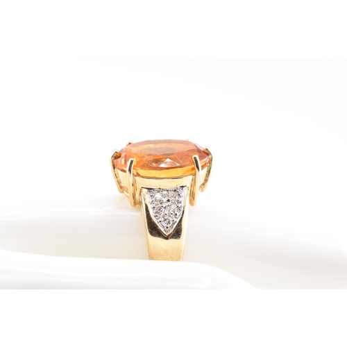 135 - A hallmarked 9ct gold, citrine and diamond ring. The 9ct yellow gold ring set with a central six cla... 