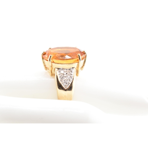 135 - A hallmarked 9ct gold, citrine and diamond ring. The 9ct yellow gold ring set with a central six cla... 