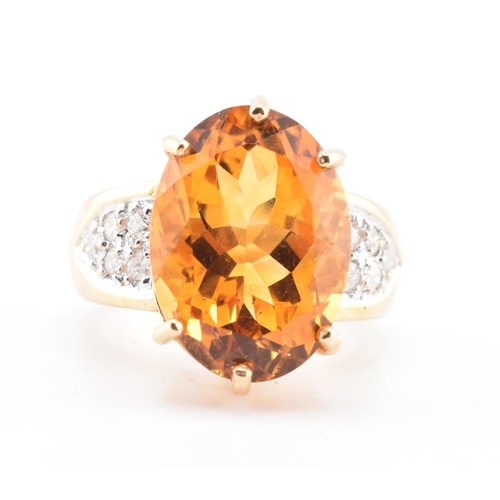 135 - A hallmarked 9ct gold, citrine and diamond ring. The 9ct yellow gold ring set with a central six cla... 