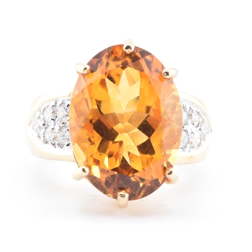 135 - A hallmarked 9ct gold, citrine and diamond ring. The 9ct yellow gold ring set with a central six cla... 