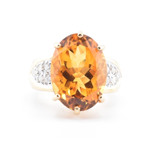 135 - A hallmarked 9ct gold, citrine and diamond ring. The 9ct yellow gold ring set with a central six cla... 