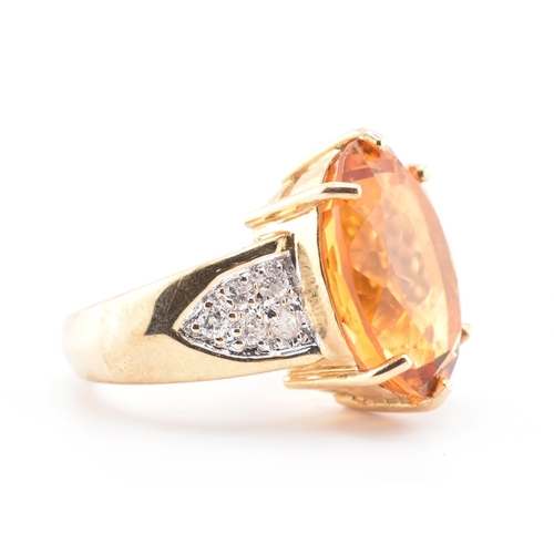 135 - A hallmarked 9ct gold, citrine and diamond ring. The 9ct yellow gold ring set with a central six cla... 