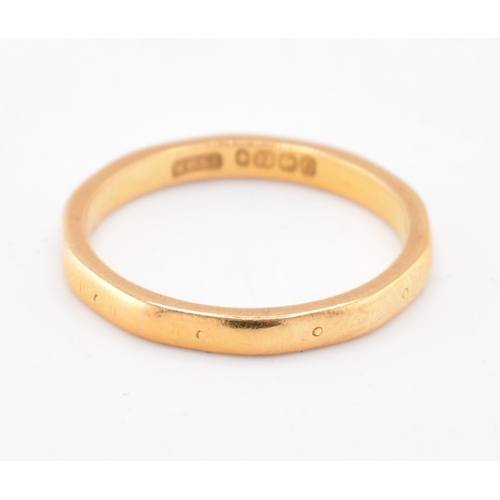 137 - A hallmarked 22ct gold band ring. The 22ct yellow gold band ring having small stamped circles around... 