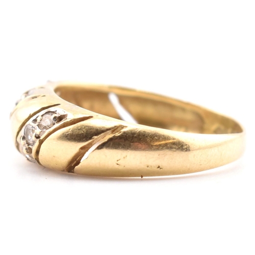 138 - An 18ct gold and CZ dome ring. The 18ct yellow gold dome ring set with three slanted rows of three r... 