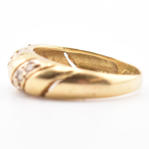 138 - An 18ct gold and CZ dome ring. The 18ct yellow gold dome ring set with three slanted rows of three r... 