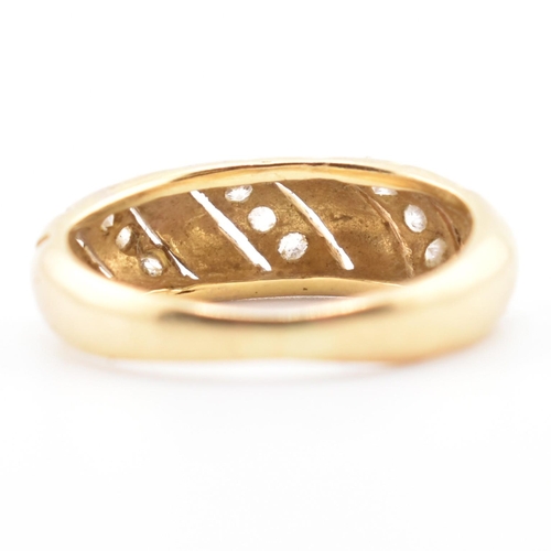 138 - An 18ct gold and CZ dome ring. The 18ct yellow gold dome ring set with three slanted rows of three r... 